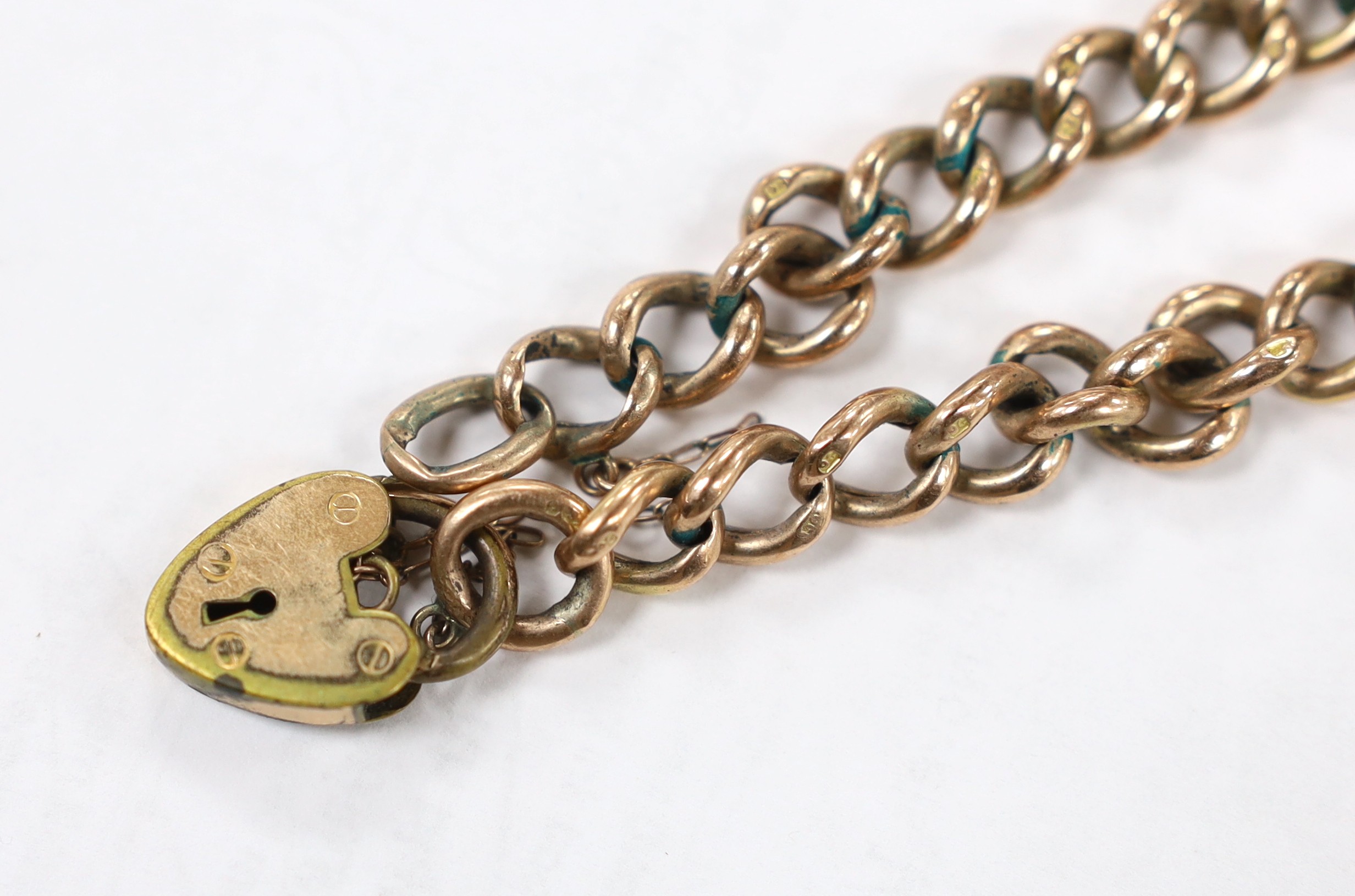 A 9ct curb link bracelet with gold plated heart shaped padlock clasp, 19.5cm, gross weight 10.8 grams.
